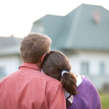 Happy Home Owners in front of home