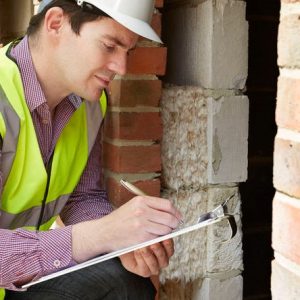 Architect Checking Insulation During House Construction